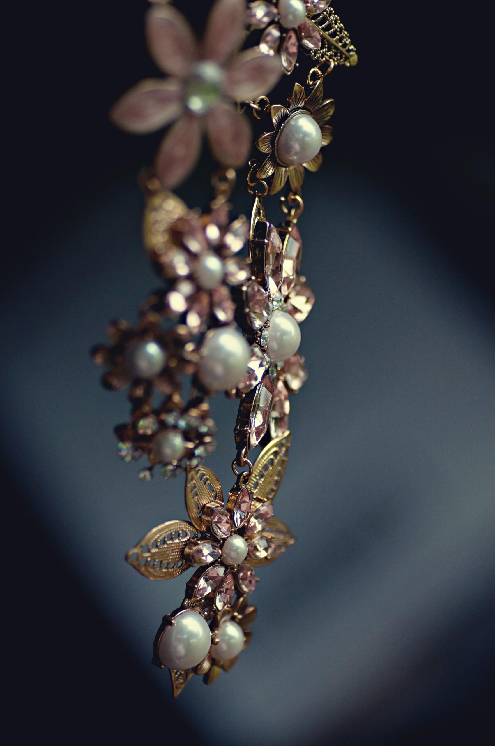 Close-up of a luxurious floral necklace featuring pearls and gemstones with a vintage charm.